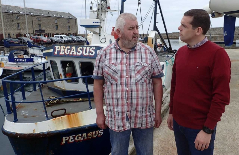 Douglas Ross MP with Douglas Scott, fisherman at his boat in Lossiemouth