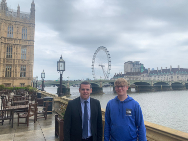 Douglas and Jack stand on the terrace of Westminster overlooking the London Eye