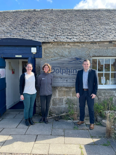 Douglas stands outside the Scottish Dolphin Centre with members of staff